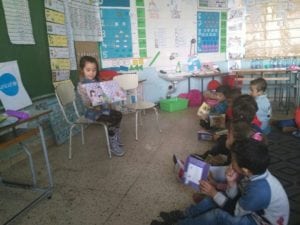 Children reading books donated by Thuraya at a school in Lebanon