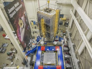 NASA engineers and technicians position the James Webb Space Telescope (inside a large tent) onto the shaker table used for vibration testing. Credits: NASA/Chris Gunn