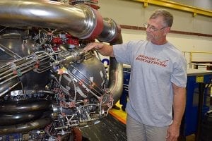 An Aerojet Rocketdyne technician inspects the 3D-printed pogo accumulator assembly on an RS-25 development engine at the Aerojet Rocketdyne facility located at NASA's Stennis Space Center. Photo: Aerojet Rocketdyne.