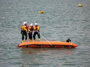 A crew of the Royal National Lifeboat Institution show their skills during a capsize drill. Photo: Wikimedia.