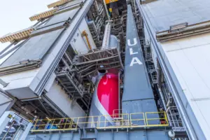 A GEM 63XL solid rocket booster is maneuvered into position for installation during Vulcan stacking operations. Photo: ULA